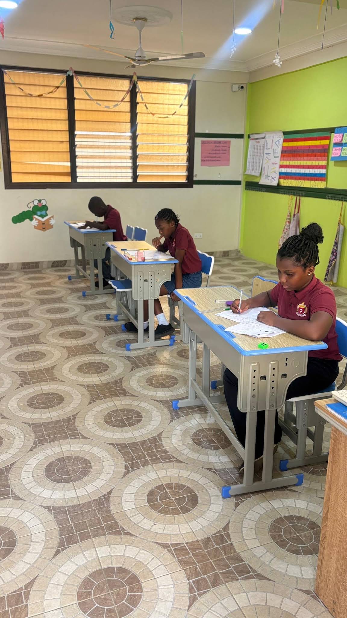 ALLSWELL Premier School learners working at individual desks in a classroom