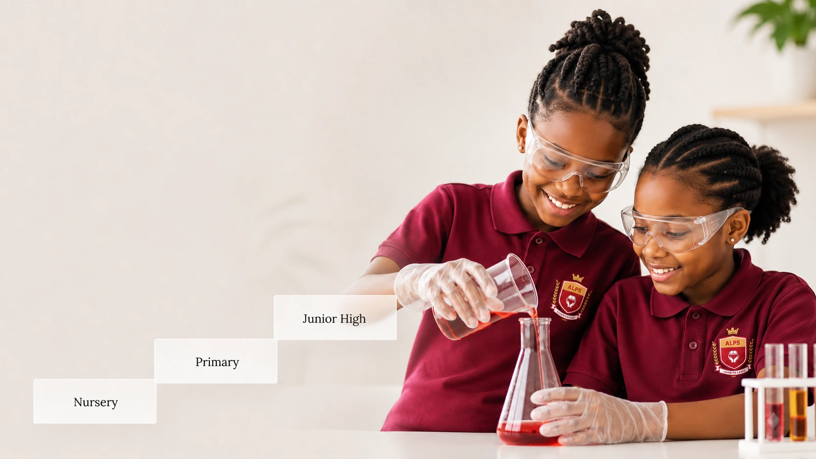 Two ALLSWELL Premier School learners wearing safety glasses during a practical science activity
