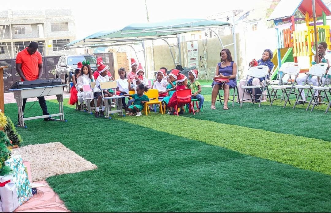 Learners seated near a keyboard during an outdoor ALLSWELL Premier School Carol Service performance